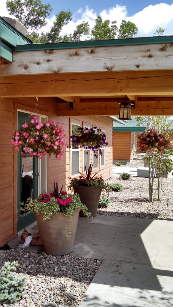 Covered walkway at Killdeer Mountain Park with landscaped planters and well-maintained building exteriors