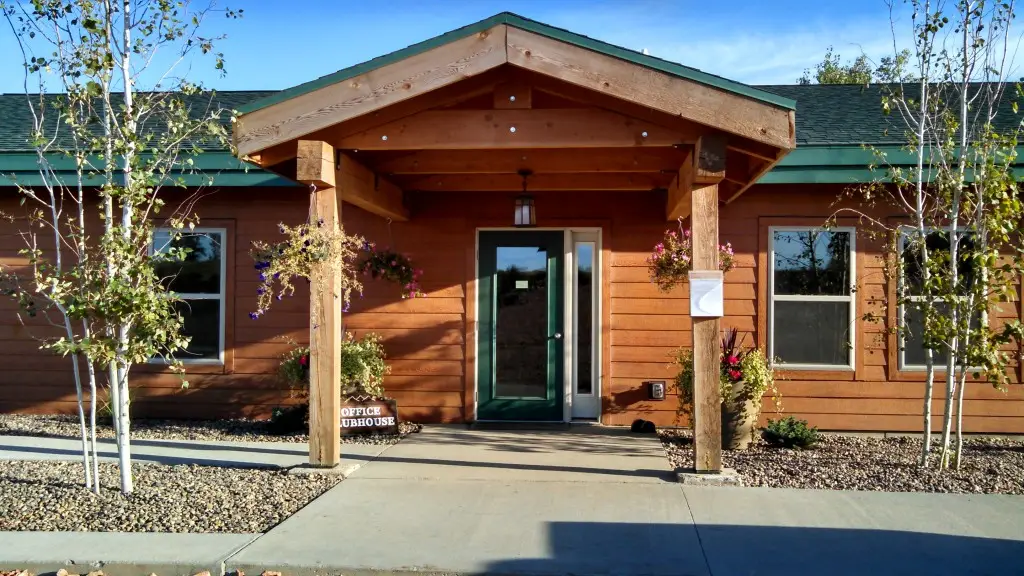 Office and clubhouse entrance at Killdeer Mountain Park with welcoming covered entry and landscaping