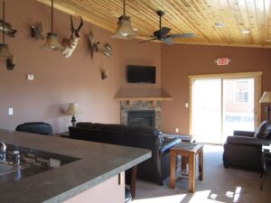 Community lounge at Killdeer Mountain Park with seating, fireplace, and shared indoor gathering space